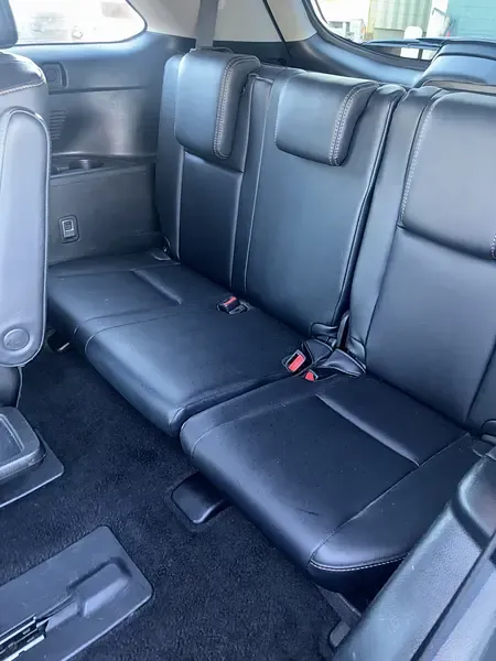 Clean black leather third-row seats after an interior detail by Dimond