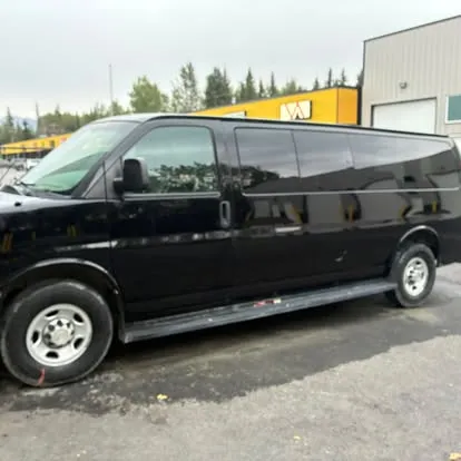 Glossy black Chevrolet Express van after an exterior wash and polish